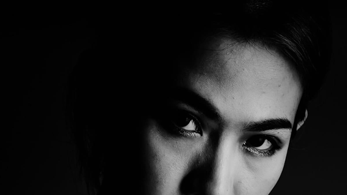 black-and-white portrait photo of person looking to the side